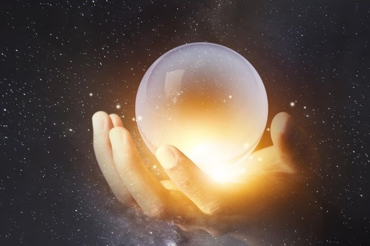hand with crystal ball-understanding law of attraction