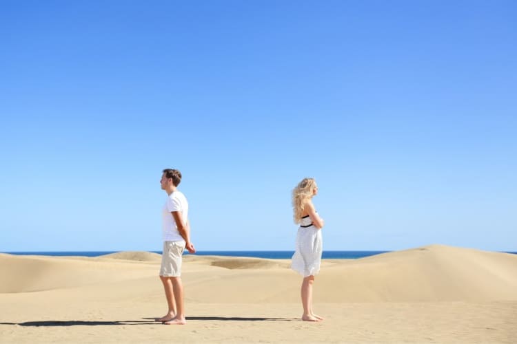man and woman on beach arguing-move on and let go
