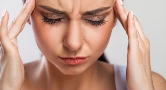 woman with a headache-how to let go of anger and stress