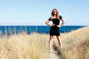 woman standing in grass-strong personality traits blog