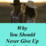 two girls in a field, never give up on your dreams