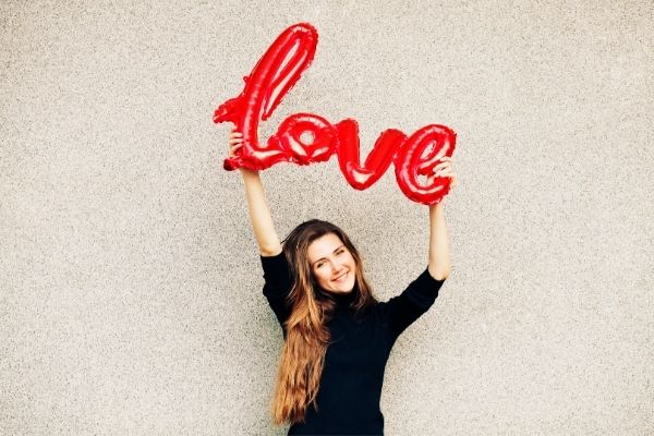 woman holding the word love-unique valentine's day ideas