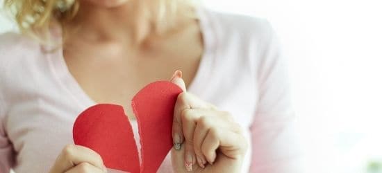 woman holding broken heart-going through a breakup blog post