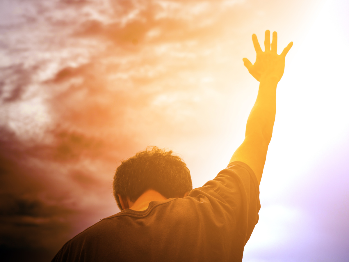 A man lifting his hands to the sky