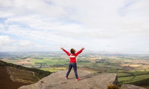 woman on a mountain-finding yourself after a breakup blog post