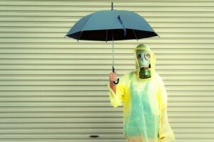 person with umbrella and gas mask
