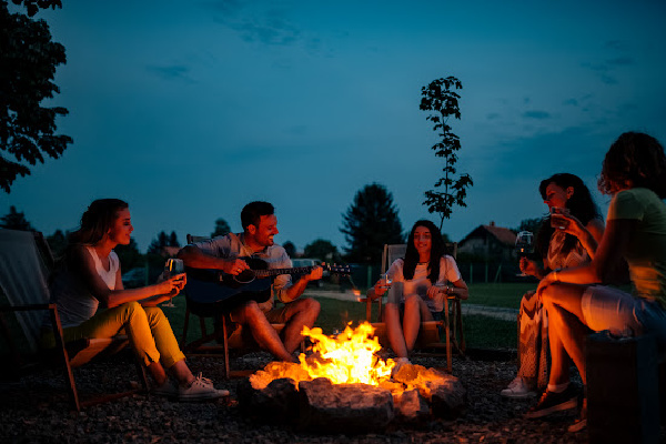 group of friends around a campfire prioritizing relationships