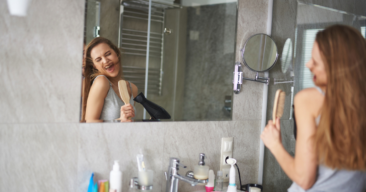 girl singing in bathroom-self care morning routine article