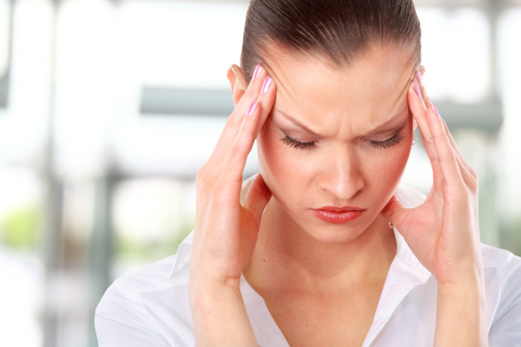 woman with headache-social media detox benefits blog