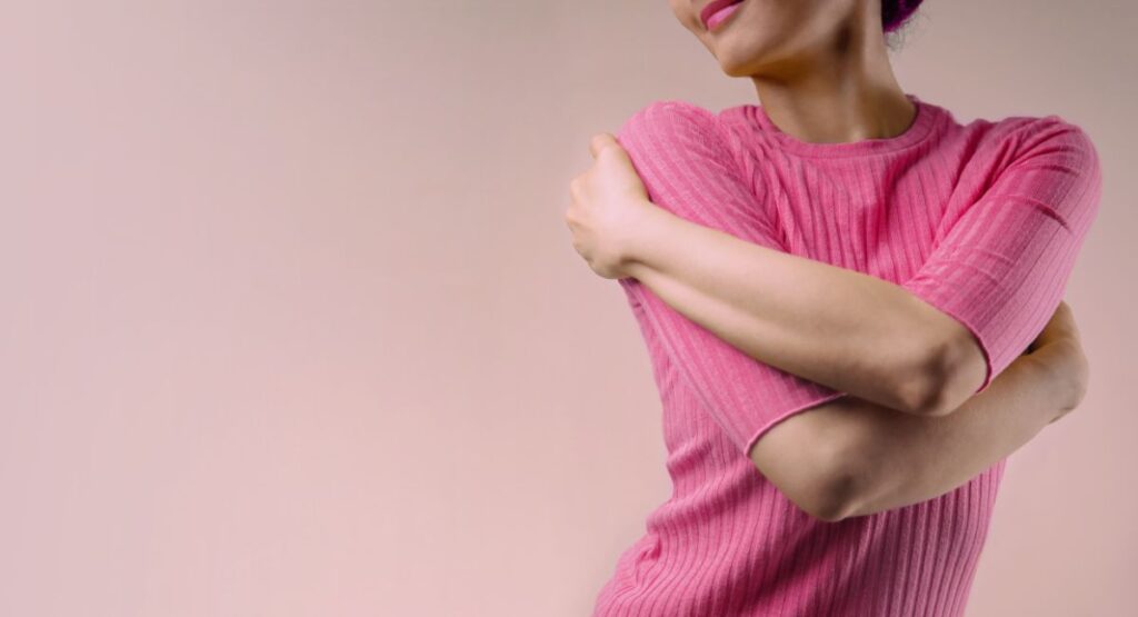 woman hugging herself - how to find self love