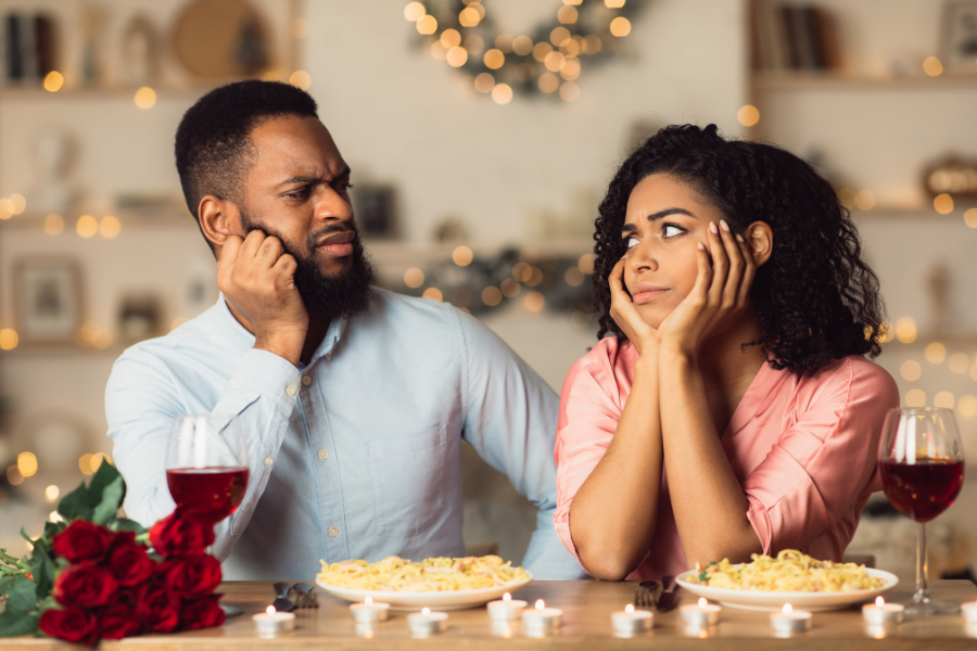 A couple looking at each other with annoyancw