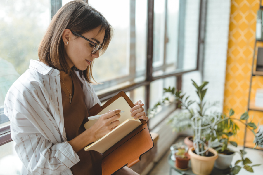 A woman writing on her journal