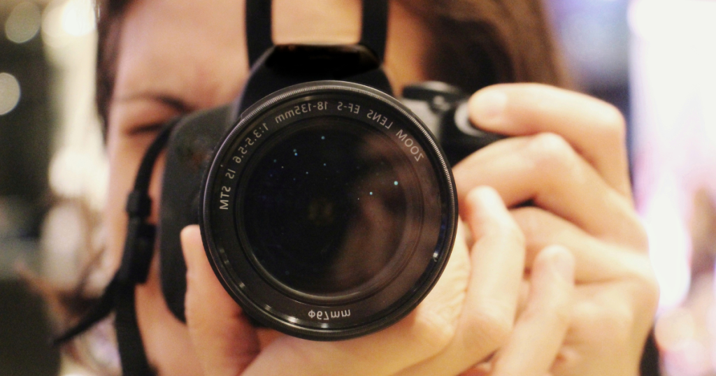 A photographer using a camera