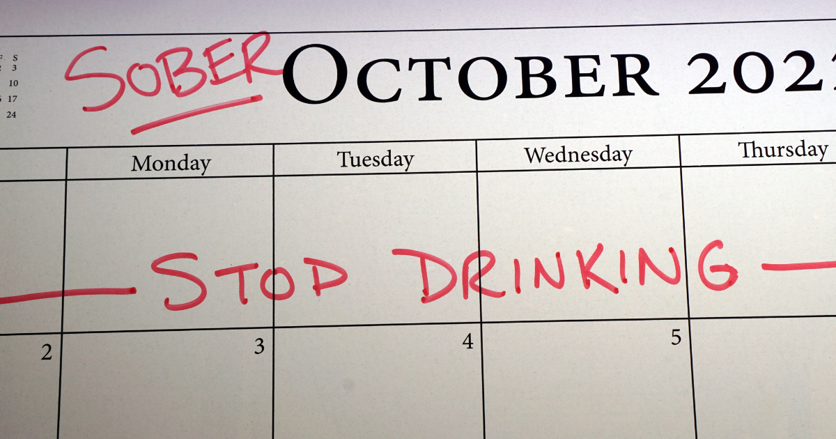 A calendar set on October with "stop drinking" sign