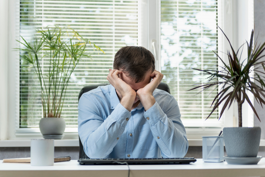 A sleepy man with workplace burnout