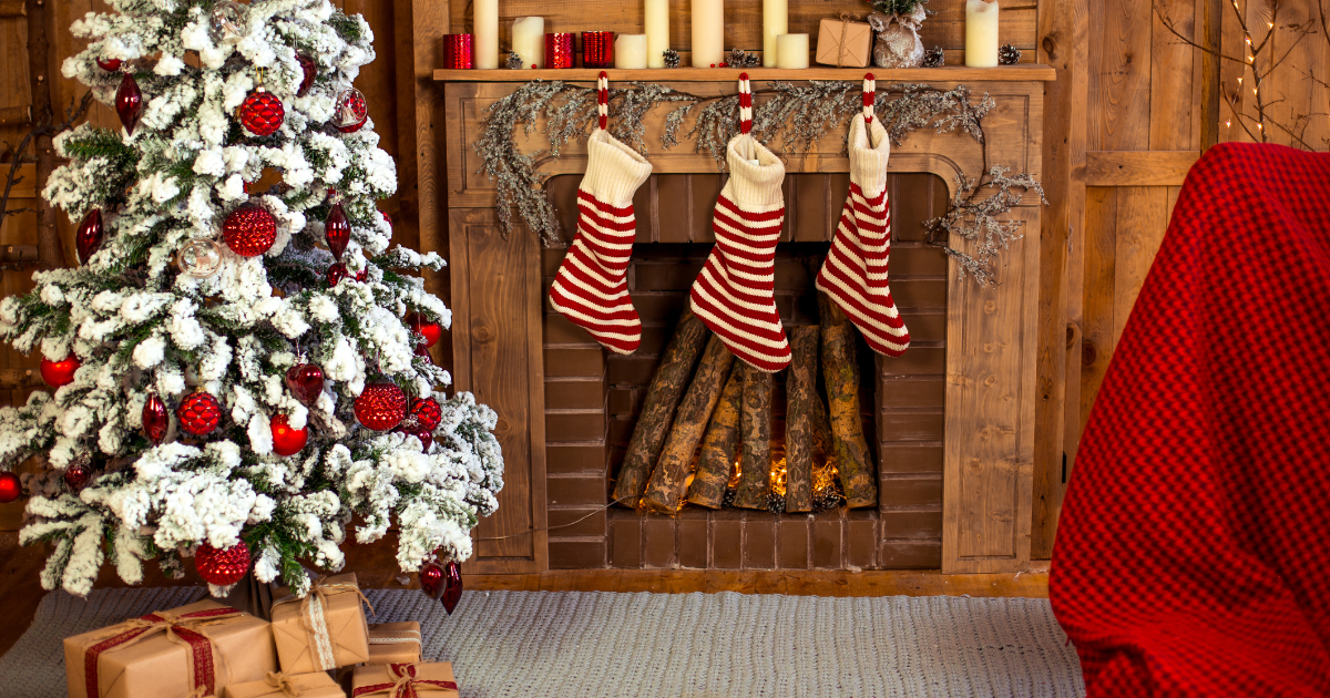 A fireplace with Christmas stockings and tree