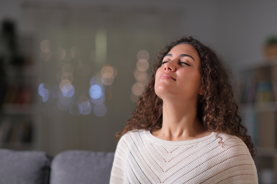 A woman practicing deep breathing exercises