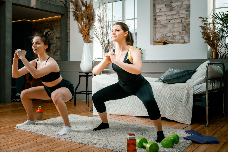 Two women doing bodyweight squats