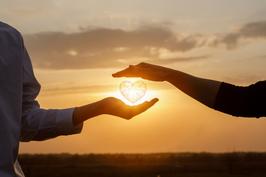 Two people holding the sun togehter