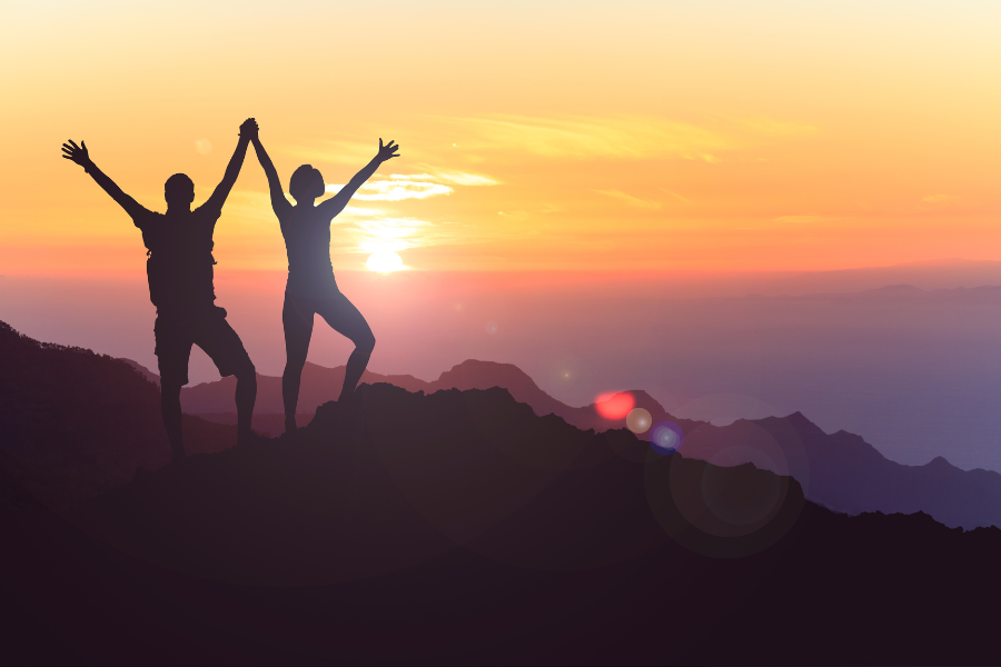 Two people standing tall on top of a mountain #SelfEsteem #Confidence #ConfidenceCoach