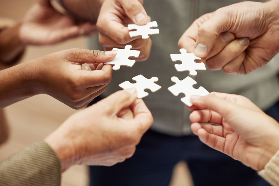 People holding different parts of a puzzle #EffectiveCommunication #CommunicatitonSkills