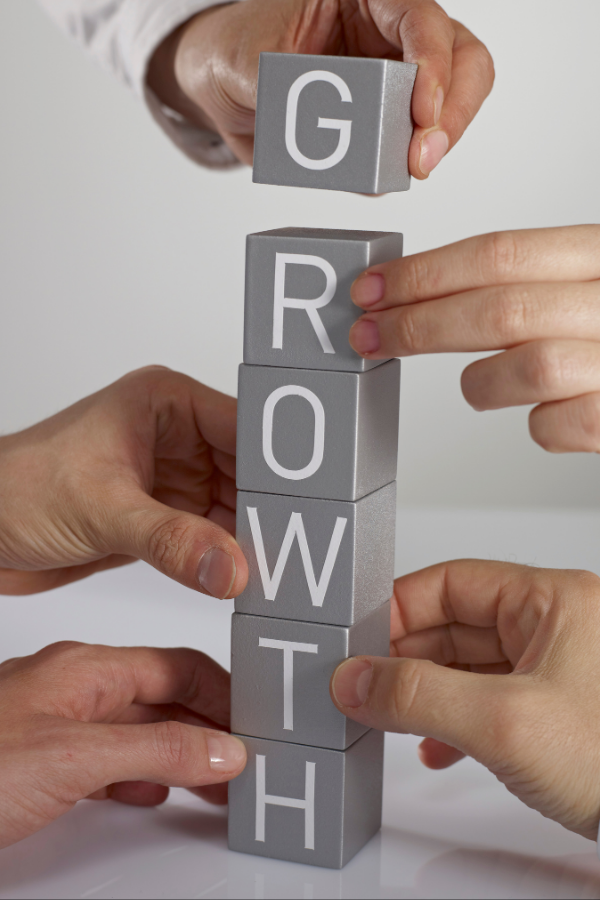 A stack of cubes spelling out the word "growth" #GrowthMindset #BrightFuture