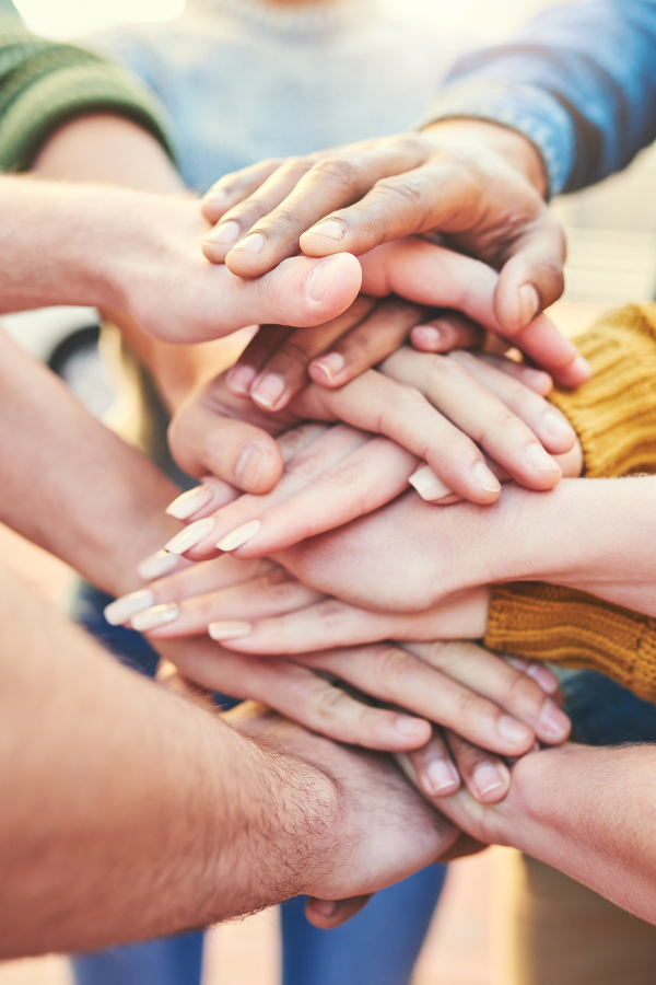 A group of people joining their hands together #Happiness30DayChallenge #Happiness #HappinessChallenge