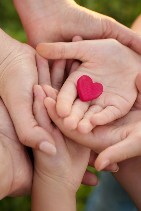 A closeup shot of family's hands holding a heart A poster about heartfelt family love letter #FamilyLove #FamilyFirst