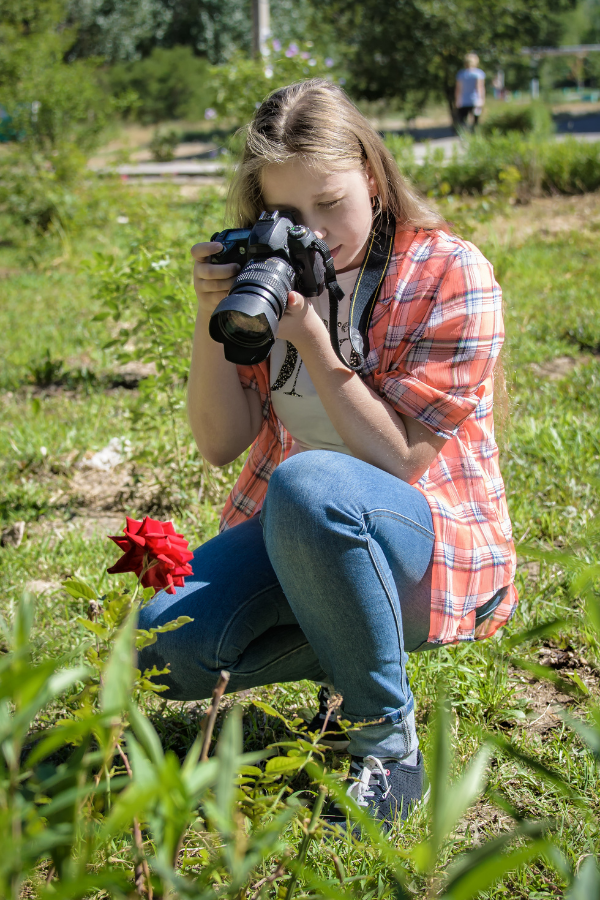 A woman taking a photo of a flower #PassionForSuccess #SuccessfulLife