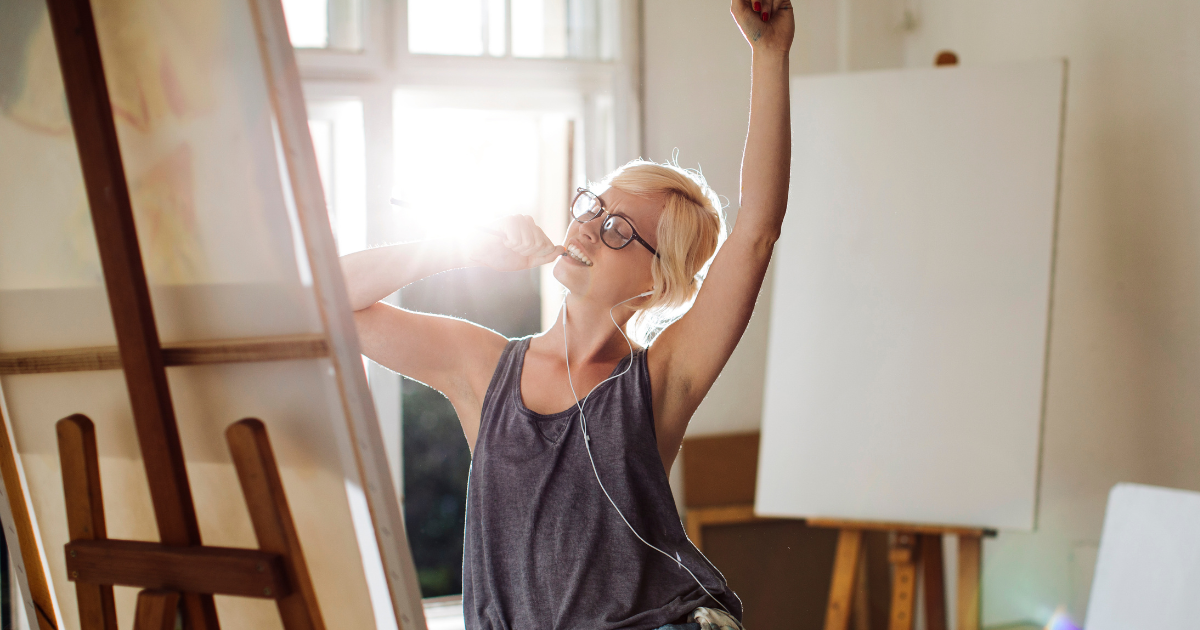 A woman painting while celebrating #FindYourPassion #PassionInLife