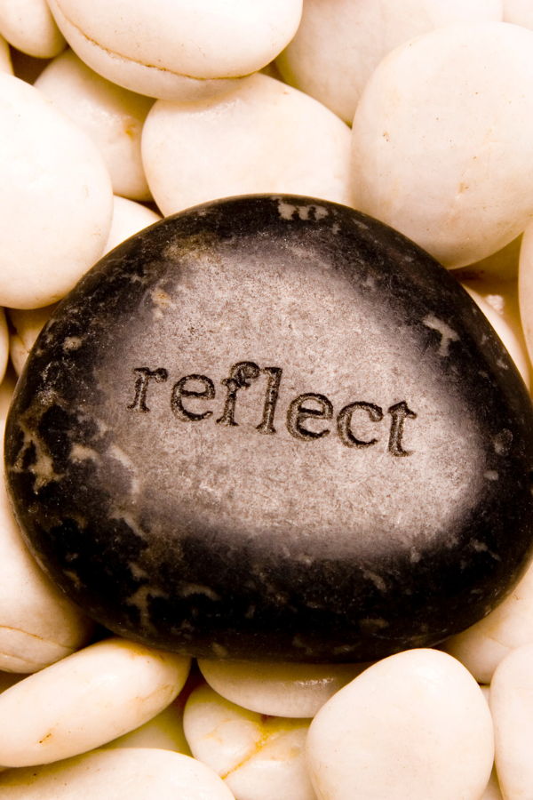 A rock with the word "reflect" wrttrr