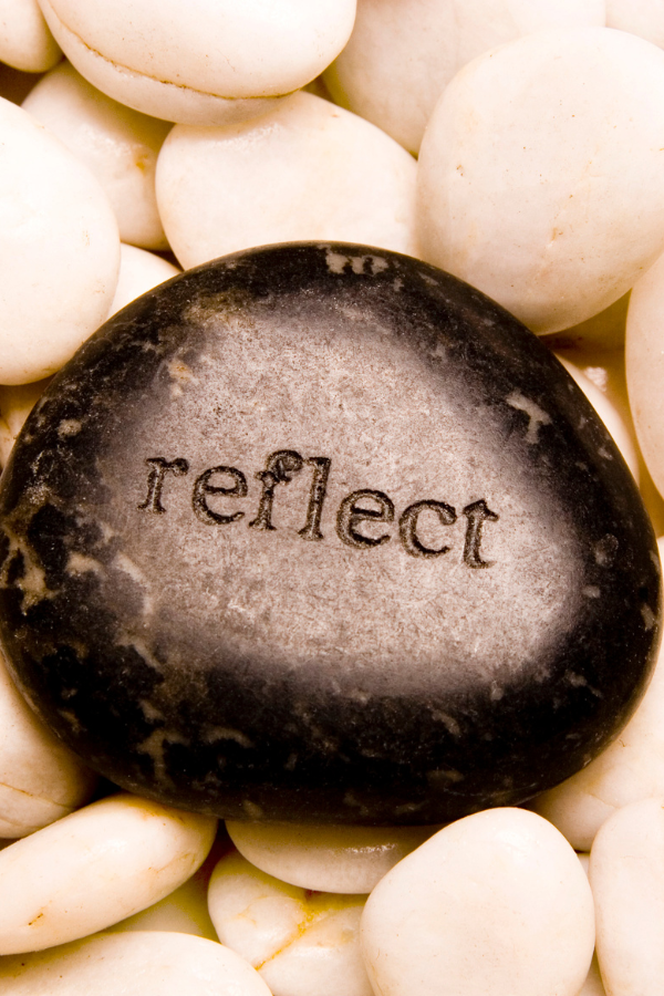 A pebble with the word "reflect" on it #TrustTheProcess LiveLifeToTheFullest