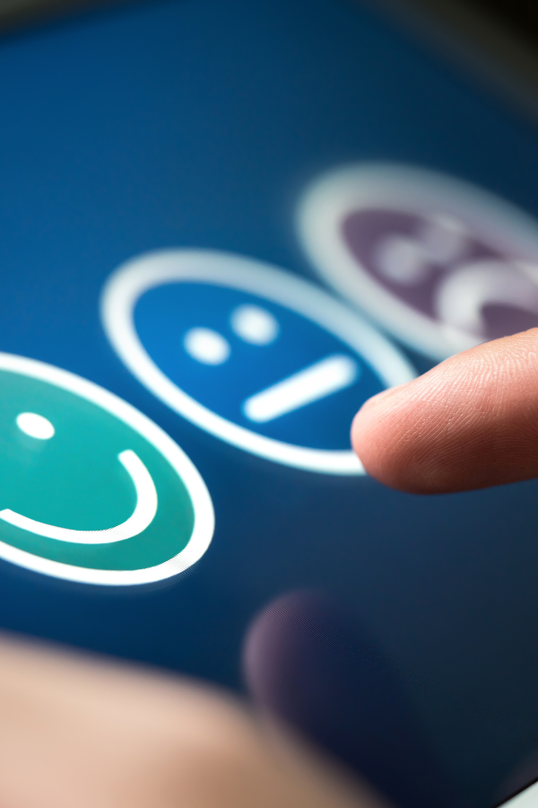 A person choosing between three emojis as feedback #EmotionalIntelligence #BetterHabits