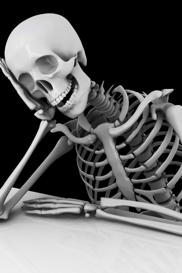 A skeleton resting its head on its hand #HalloweenParty #HalloweenThemes