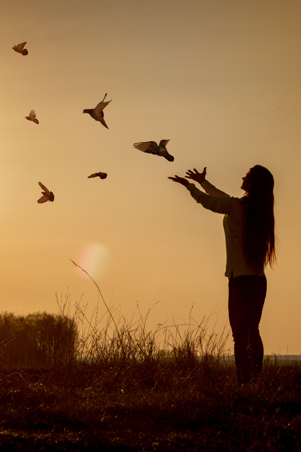 A woman setting birds free #TrustTheProcess LiveLifeToTheFullest