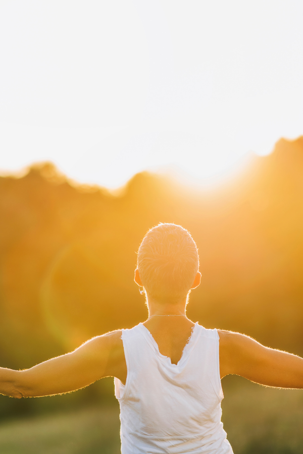 A woman spreading her arms while looking at the sun #LoveYourself #SelfLove