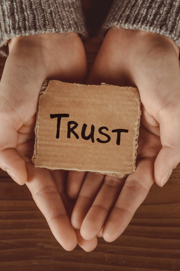 The word "trust" written on a piece of cardboard #RelationshipBoredom #Relationship