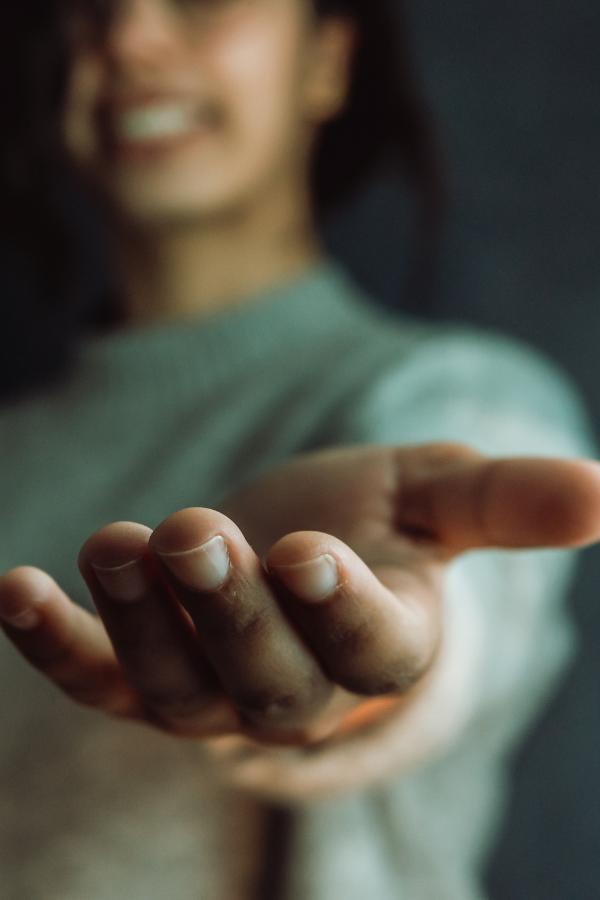 A woman extending her hand to show empathy #EmotionalIntelligence #BetterHabits