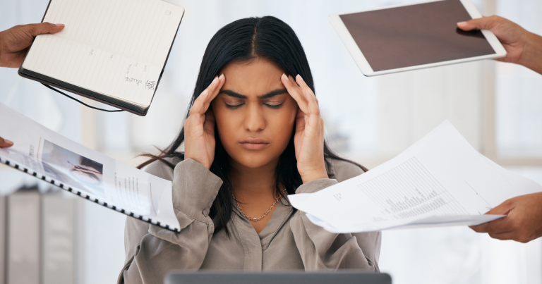 A woman feeling overwhelmed at work #OverwhlemedAtWork #WorkAnxiety