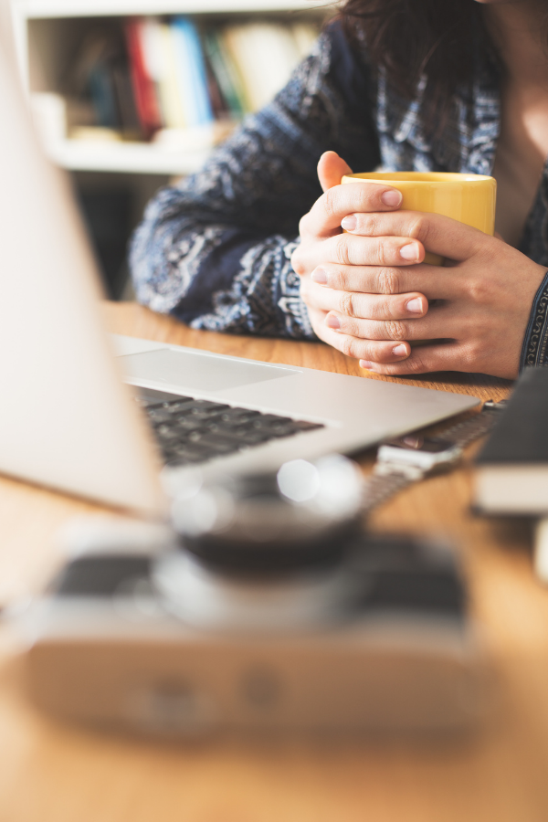 A person holding a cup of drink while working #FindProductivity #BoostYourProductivity