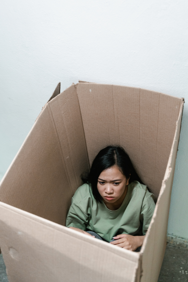 A woman caging herself in a box that represents her fear of stepping out #EmbraceChange #TransformYourLife