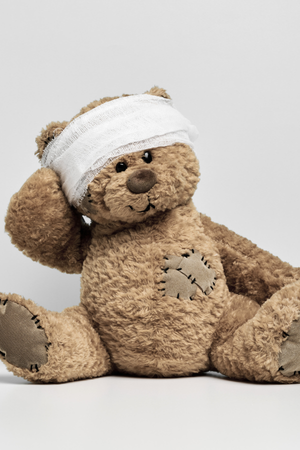 A toy bear with bandage on his head #BreakGenerationalTrauma #OvercomeTrauma