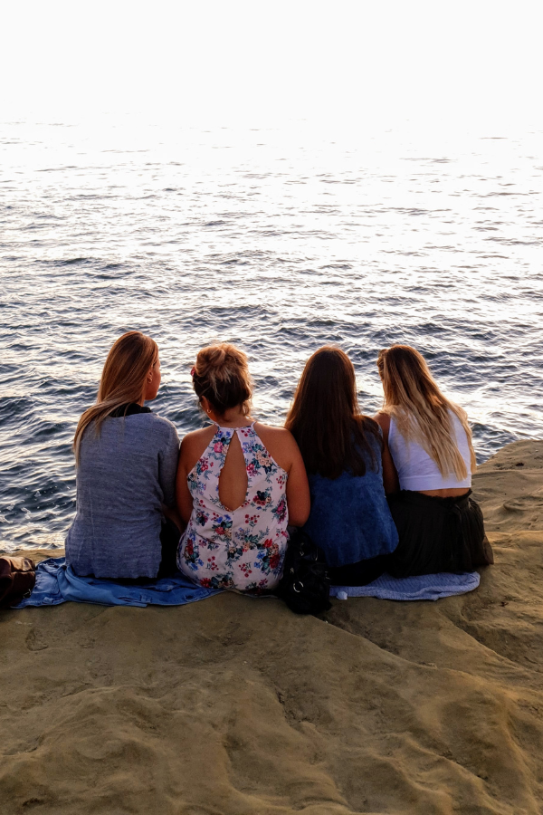 A group of friends hanging out by the ocean #BreakGenerationalTrauma #OvercomeTrauma