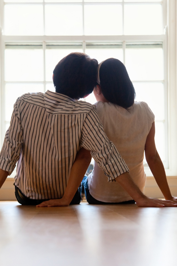 A couple sitting in the floor, leaningon each other #Vulnerability #RelationshipVulnerability