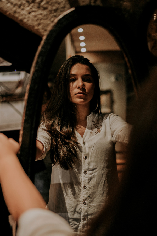 A woman looking at her reflection in the mirror #MainCharacterEnergy #MainCharacter