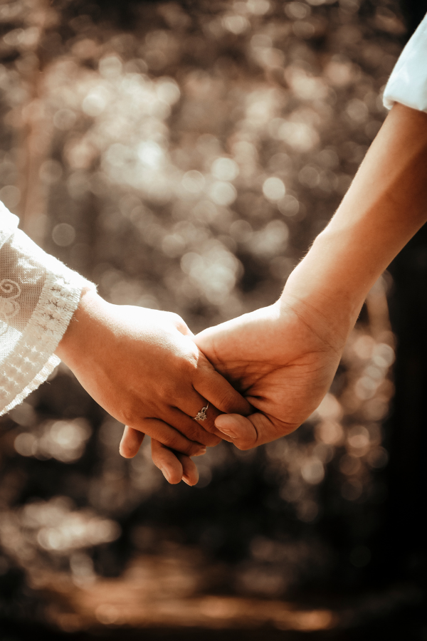 Two people holding hands