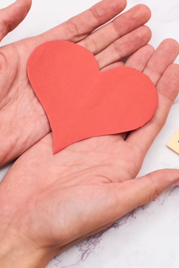 A woman holding a heart cut-out