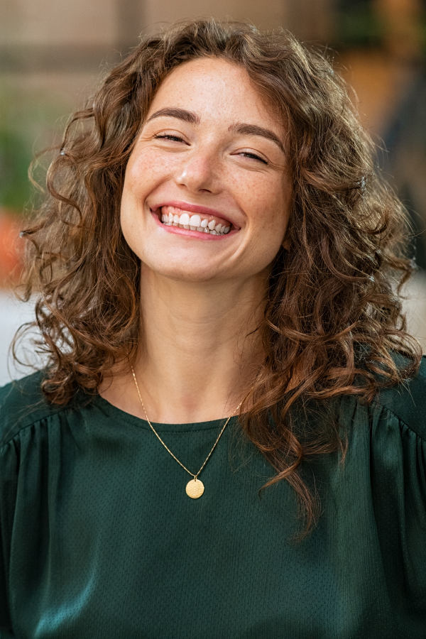 A happy woman smiling from ear to ear