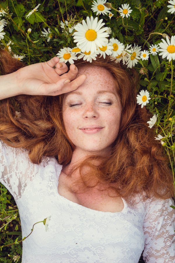 A woman feeling content while lying on the ground