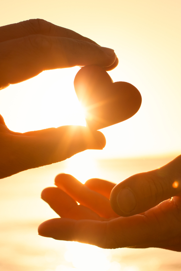 A person giving another person a heart